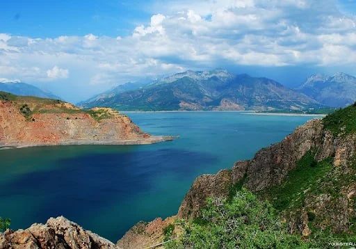 Turquoise water held between dry summer hills in the Ugam-Chatkal range, north-east of Tashkent.