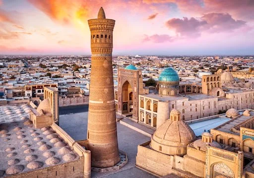 The 1127 minaret rising over Bukhara, its shaft banded with a dozen different brick patterns.